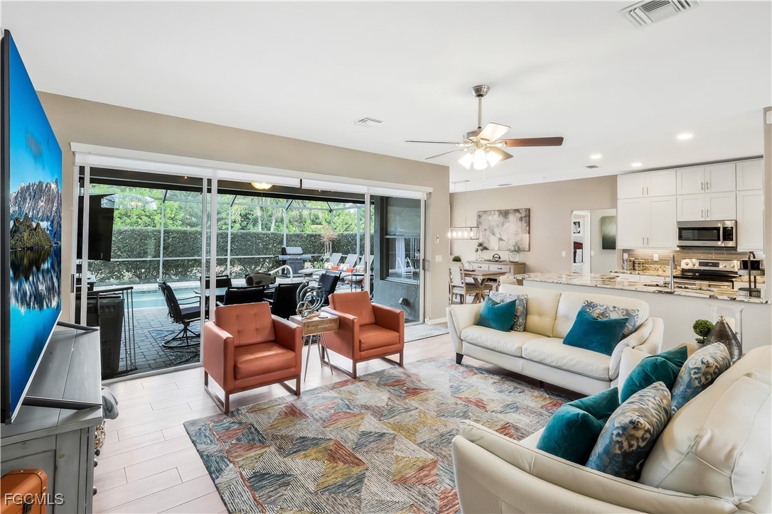 15047 Balmoral Loop Fort Myers, FL 33919 - Photo 14 of 37 a living room with furniture and a large window