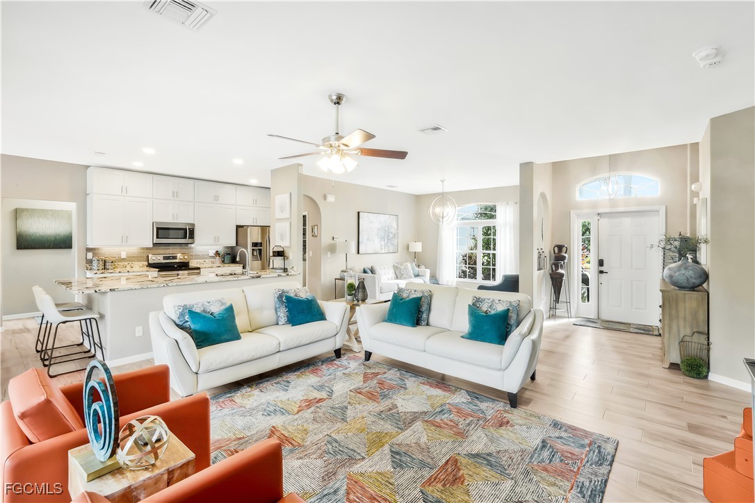 15047 Balmoral Loop Fort Myers, FL 33919 - Photo 15 of 37 a living room with furniture and view of kitchen