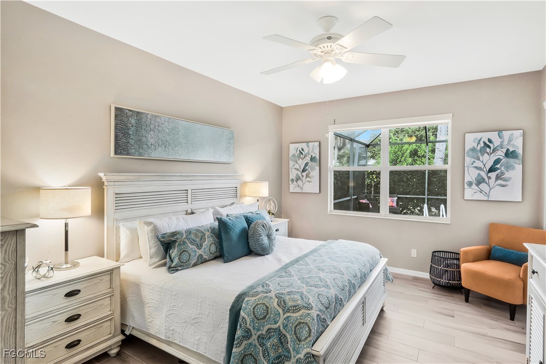 15047 Balmoral Loop Fort Myers, FL 33919 - Photo 18 of 37 a bedroom with a large bed and a couch