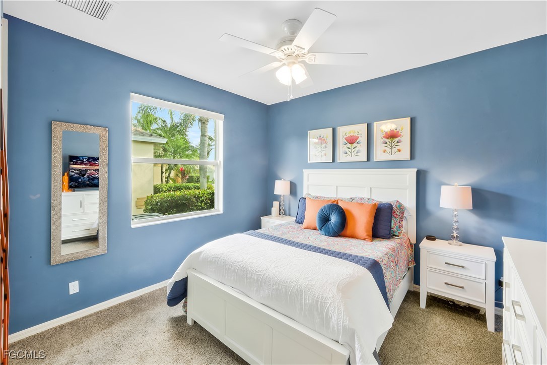 15047 Balmoral Loop Fort Myers, FL 33919 - Photo 20 of 37 a bedroom with a bed and a chandelier