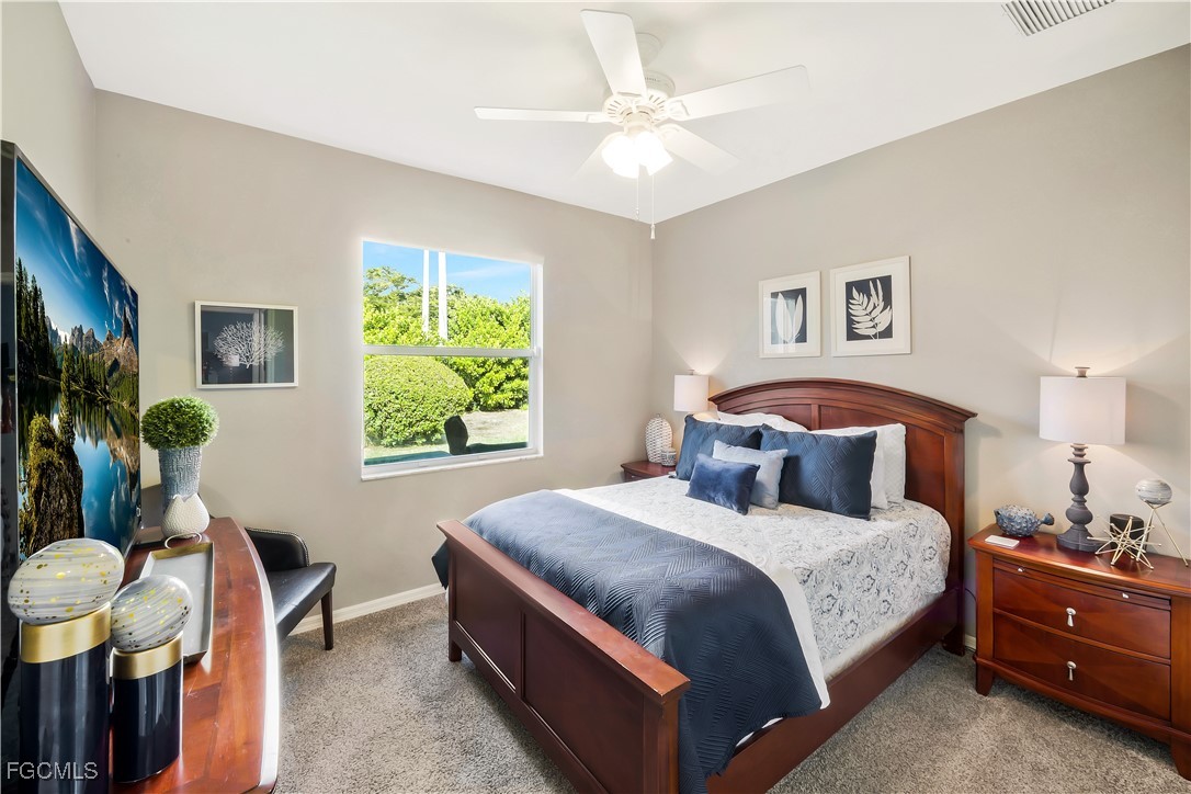 15047 Balmoral Loop Fort Myers, FL 33919 - Photo 21 of 37 a bedroom with a bed and a chandelier