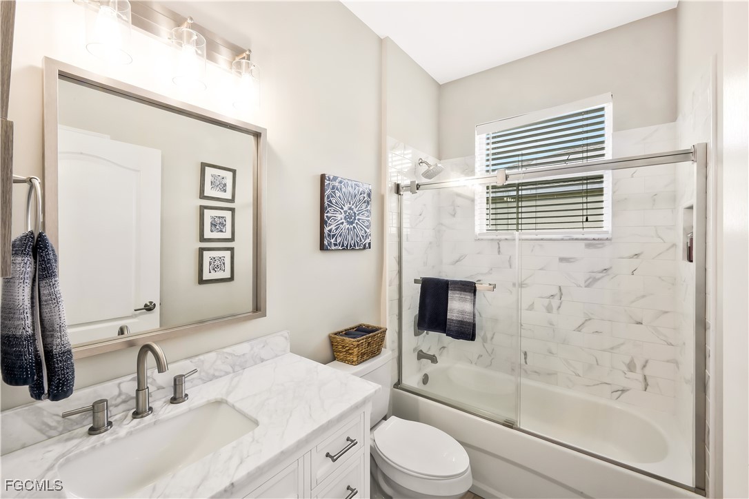 15047 Balmoral Loop Fort Myers, FL 33919 - Photo 22 of 37 a bathroom with a sink a toilet and shower