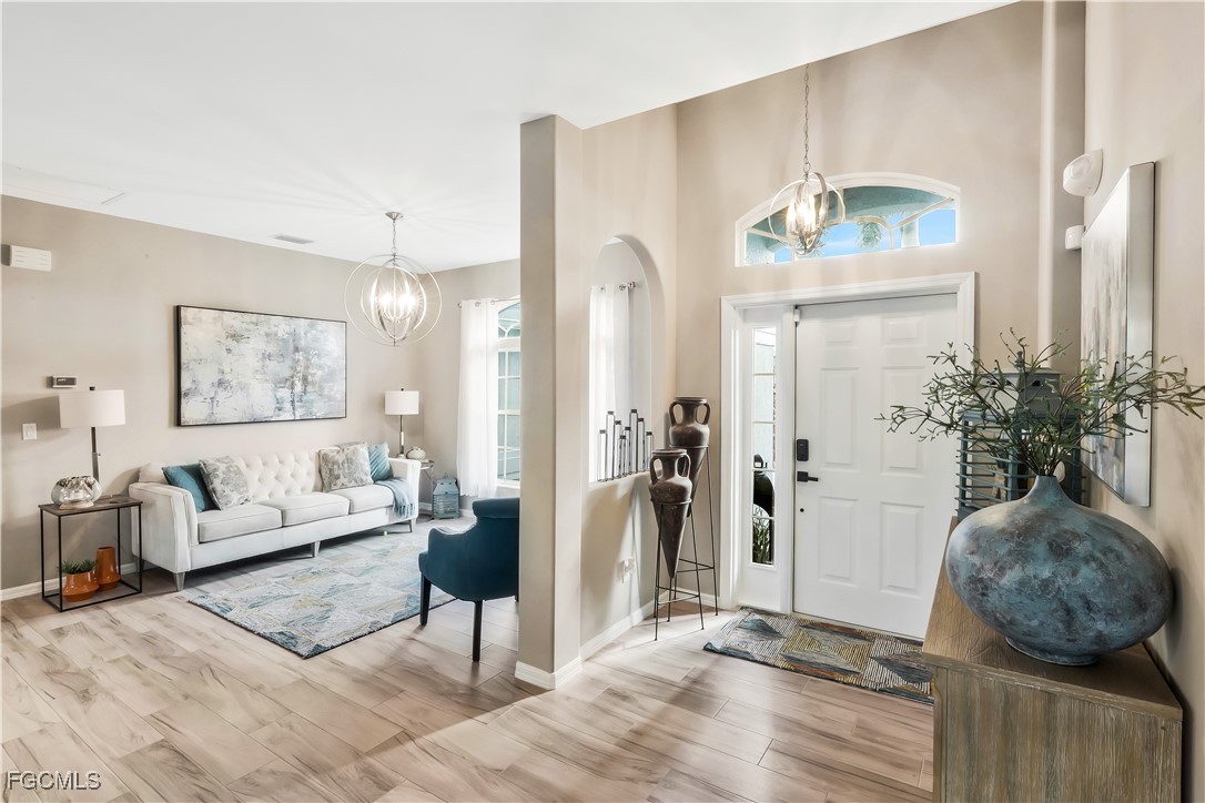 15047 Balmoral Loop Fort Myers, FL 33919 - Photo 5 of 37 a living room with furniture and a chandelier