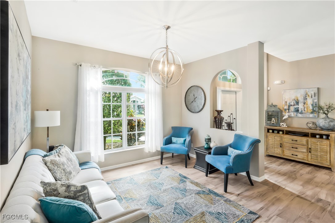 15047 Balmoral Loop Fort Myers, FL 33919 - Photo 6 of 37 a living room with furniture a fireplace and a window