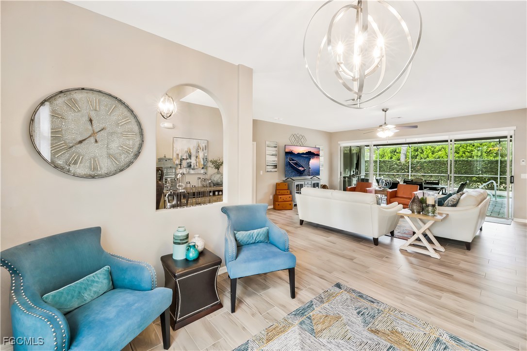 15047 Balmoral Loop Fort Myers, FL 33919 - Photo 7 of 37 a living room with furniture a fireplace and a large mirror