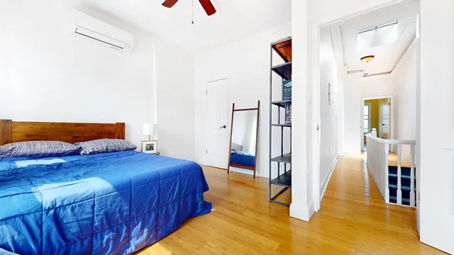 a bedroom with bed and a book shelf