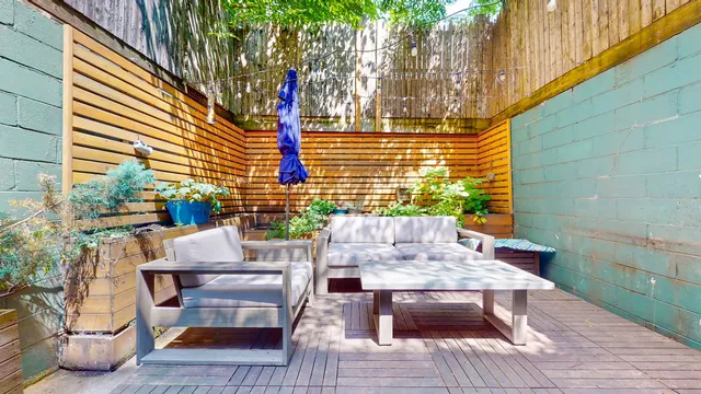 a view of a patio with a table and chairs