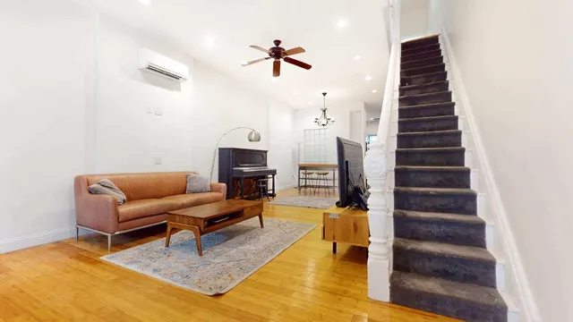 a bedroom with furniture and a flat screen tv