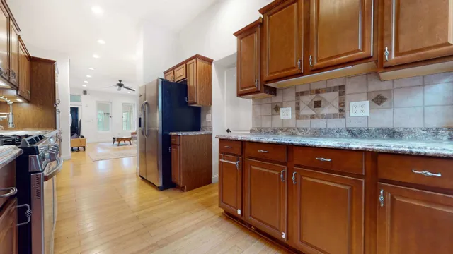 a kitchen with stainless steel appliances granite countertop a stove and a microwave