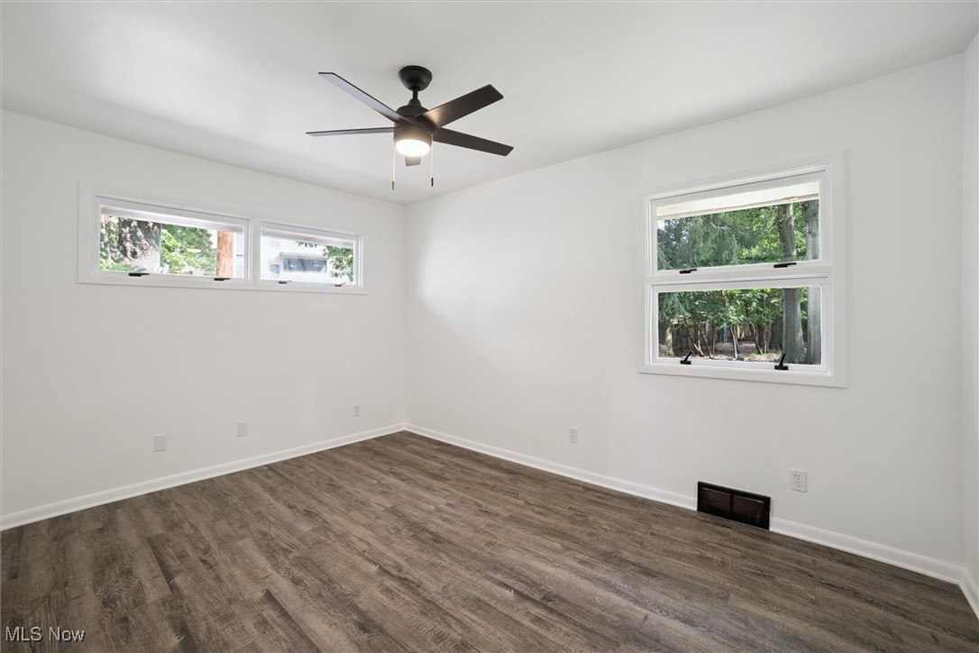 12241 Huffman Road Cleveland, OH 44130 - Photo 20 of 43 Empty room with dark wood-type flooring and a ceiling fan