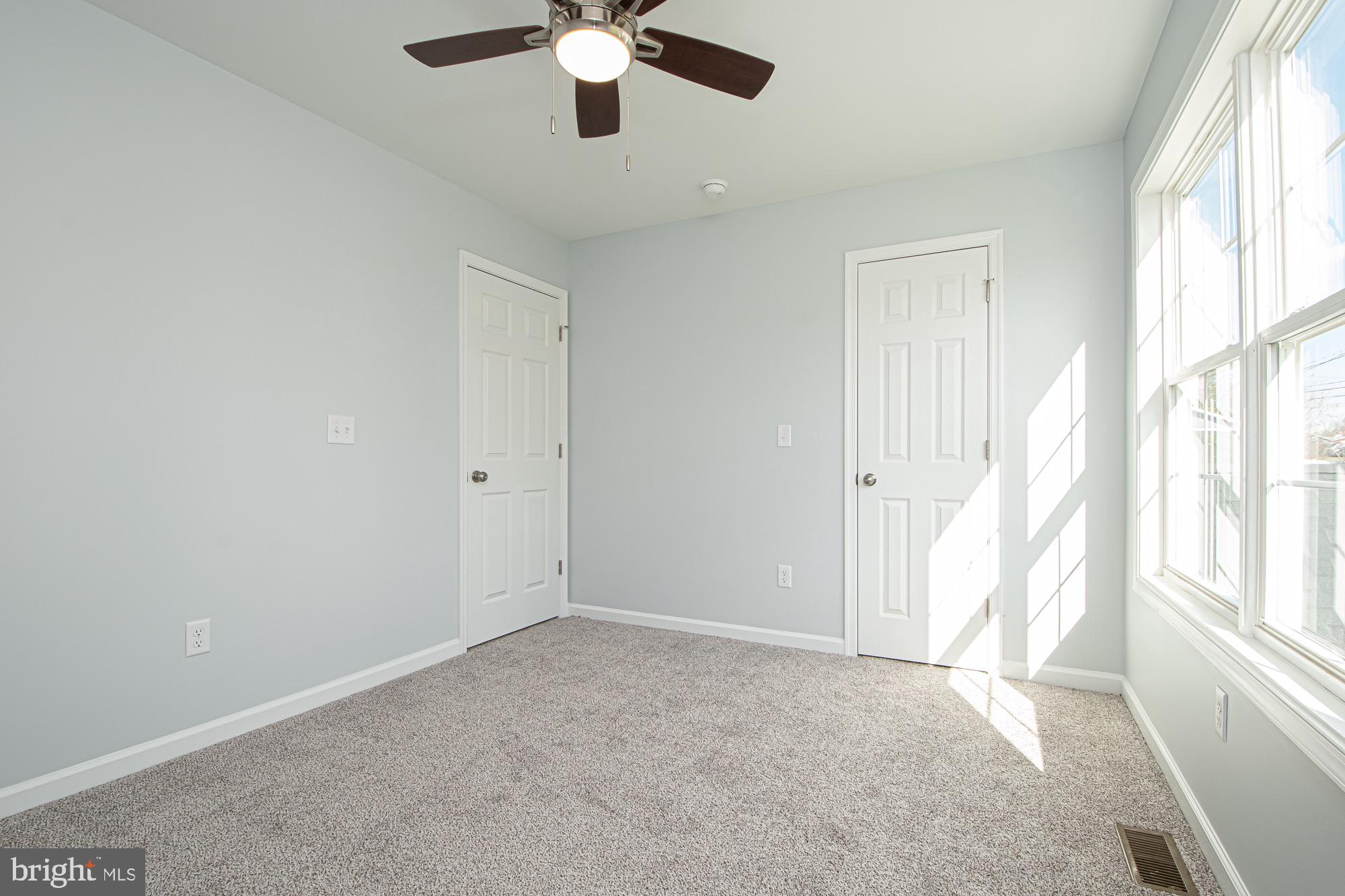 709 Ross Street Winchester, VA 22601 - Photo 25 of 40 an empty room with chandelier fan and windows