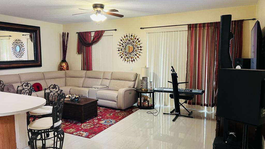 1267 Rose Gate Boulevard Riviera Beach, FL 33404 - Photo 15 of 29 a living room with furniture and a flat screen tv