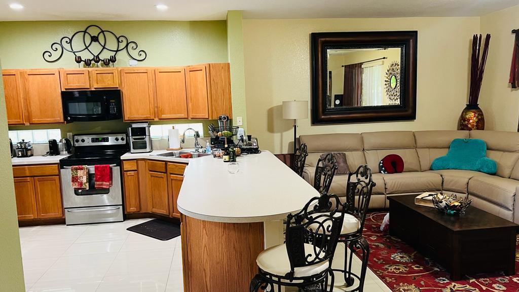 1267 Rose Gate Boulevard Riviera Beach, FL 33404 - Photo 16 of 29 a living room with furniture and a flat screen tv