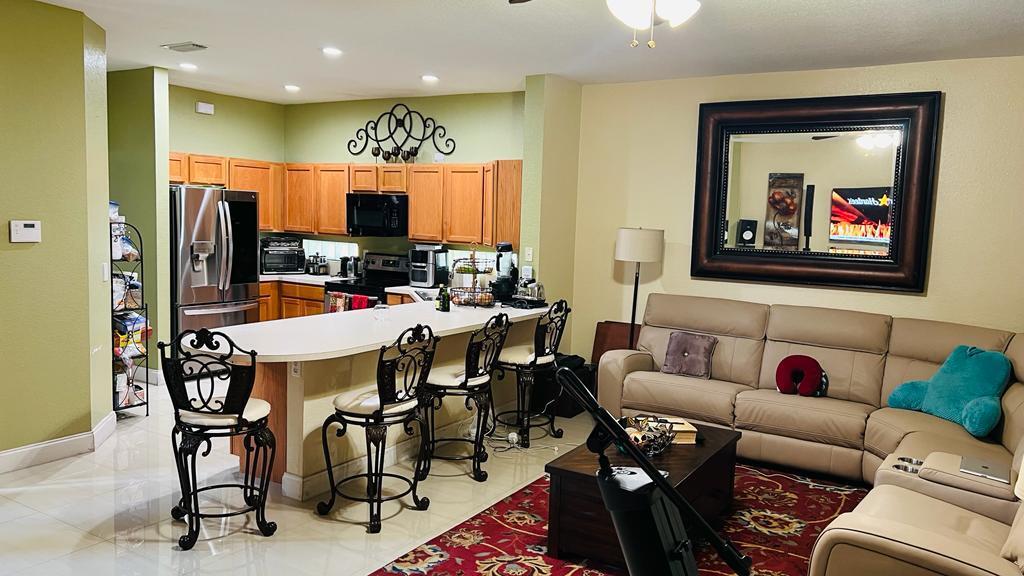 1267 Rose Gate Boulevard Riviera Beach, FL 33404 - Photo 17 of 29 a living room with furniture kitchen view and a large window