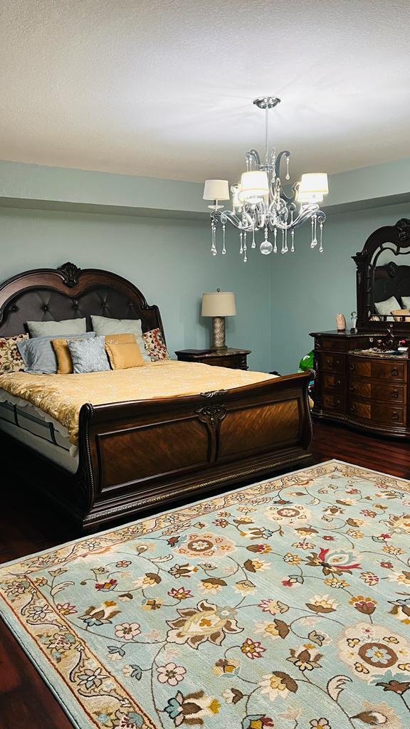 1267 Rose Gate Boulevard Riviera Beach, FL 33404 - Photo 22 of 29 a bedroom with bed and a chandelier
