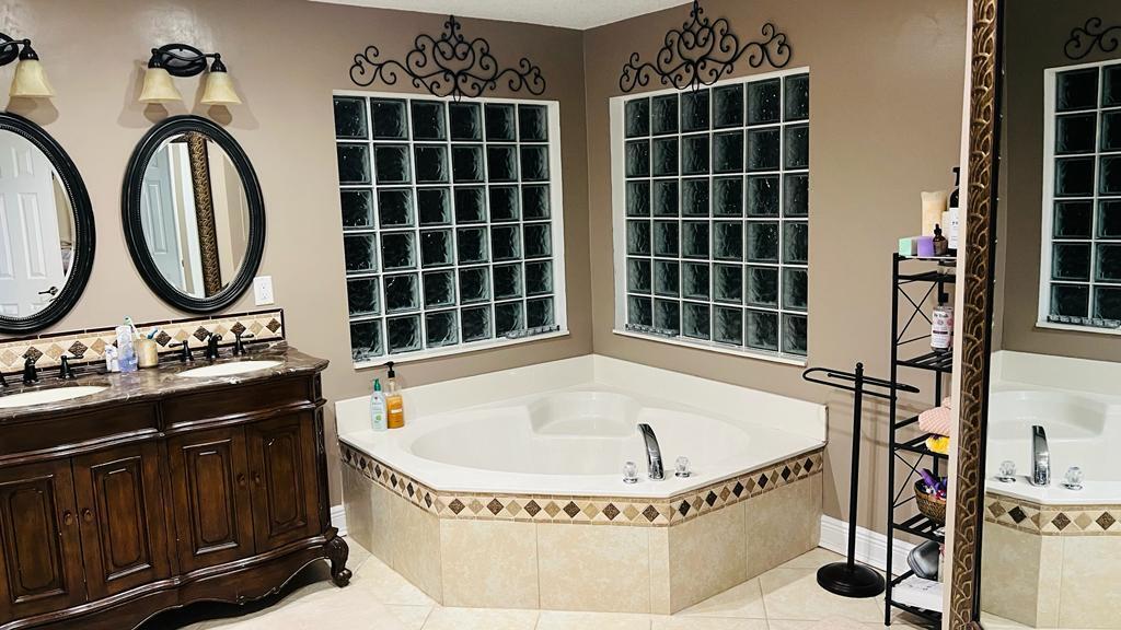 1267 Rose Gate Boulevard Riviera Beach, FL 33404 - Photo 27 of 29 a bathroom with a tub and a sink