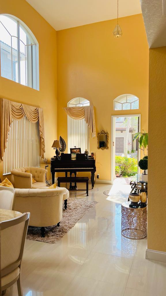 1267 Rose Gate Boulevard Riviera Beach, FL 33404 - Photo 3 of 29 a living room with couches and a potted plant on table