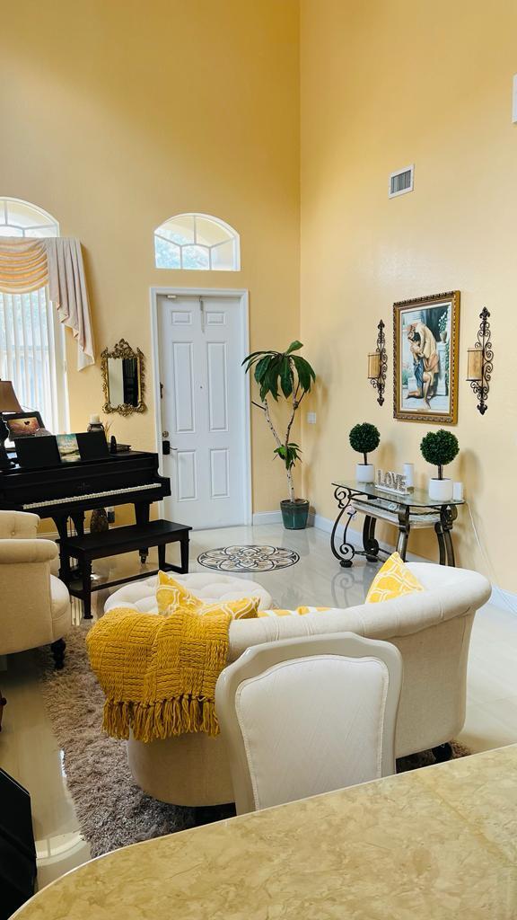 1267 Rose Gate Boulevard Riviera Beach, FL 33404 - Photo 4 of 29 a living room with furniture and a wooden floor