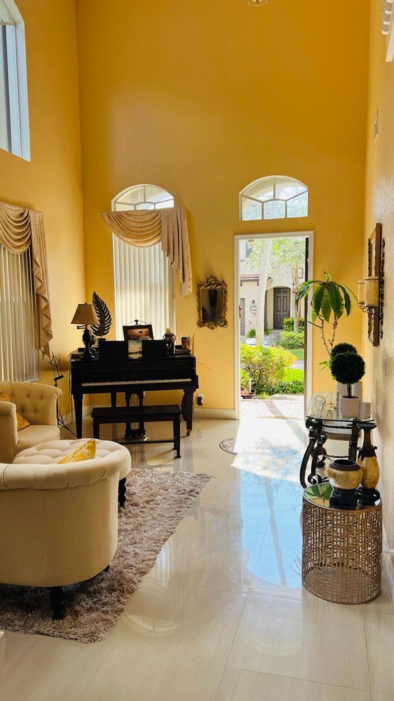 1267 Rose Gate Boulevard Riviera Beach, FL 33404 - Photo 5 of 29 a living room with furniture and a piano