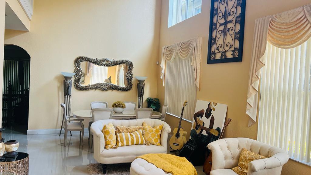 1267 Rose Gate Boulevard Riviera Beach, FL 33404 - Photo 9 of 29 a living room with furniture and a large window