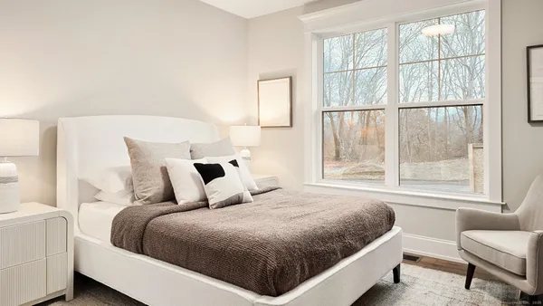 a bedroom with a large bed and a large window