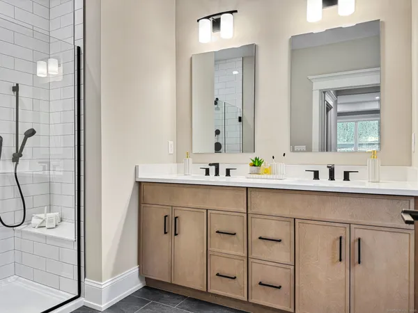 a bathroom with a double vanity sink mirror and