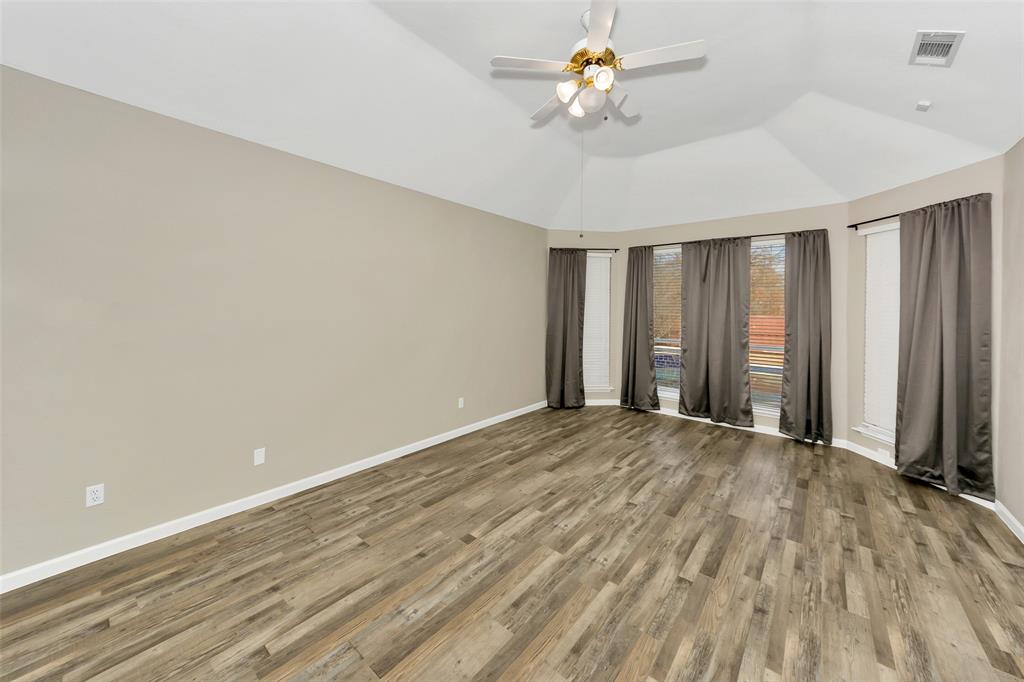 857 Summit Pointe Lewisville, TX 75077 - Photo 16 of 33 wooden floor in an empty room with a window