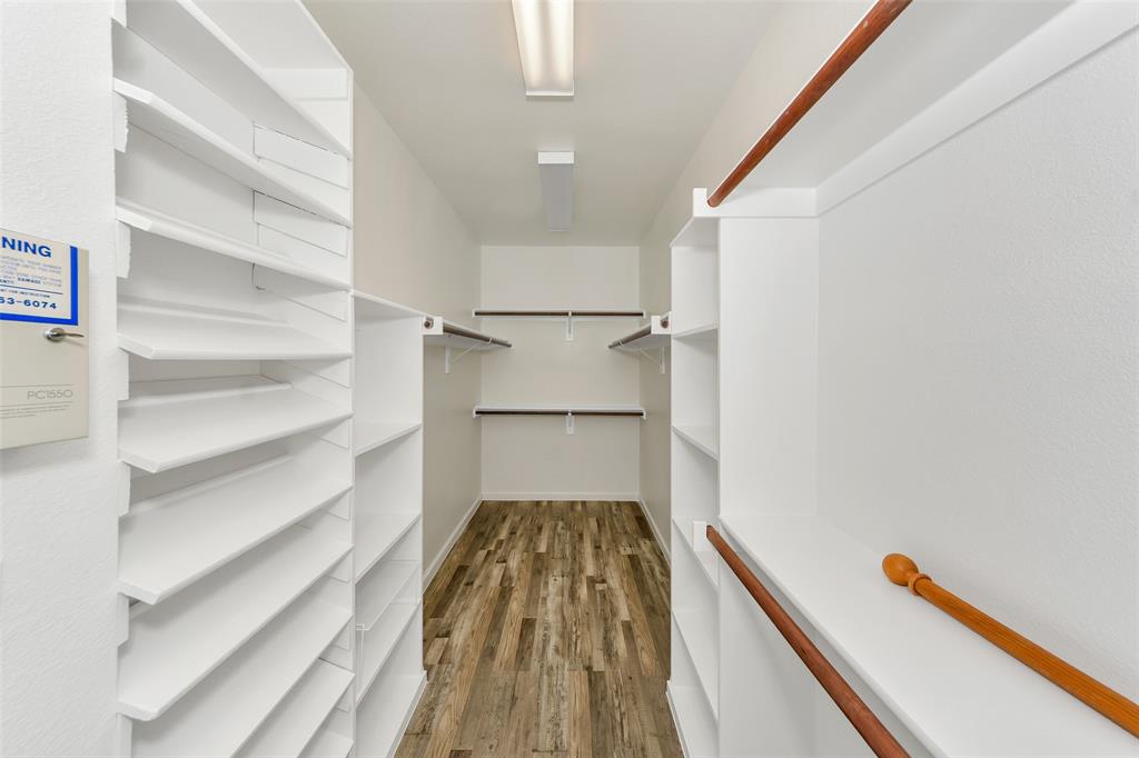 857 Summit Pointe Lewisville, TX 75077 - Photo 19 of 33 a view of a hallway with wooden floor and staircase