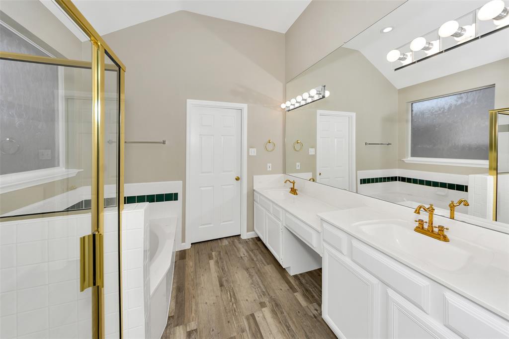 857 Summit Pointe Lewisville, TX 75077 - Photo 21 of 33 a large white kitchen with a refrigerator a sink dishwasher and a fireplace with wooden floor