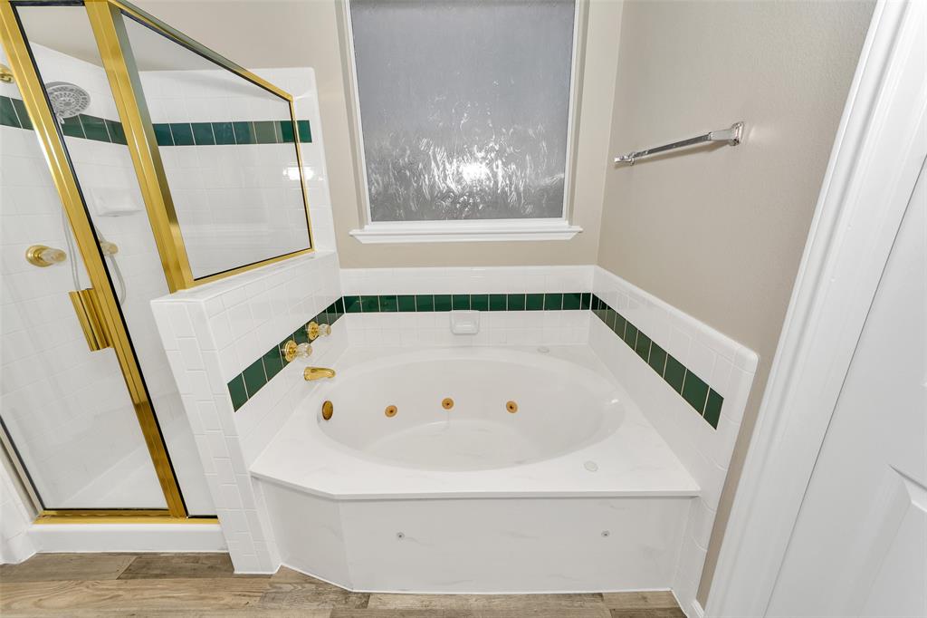 857 Summit Pointe Lewisville, TX 75077 - Photo 22 of 33 a white bath tub sitting in a bathroom