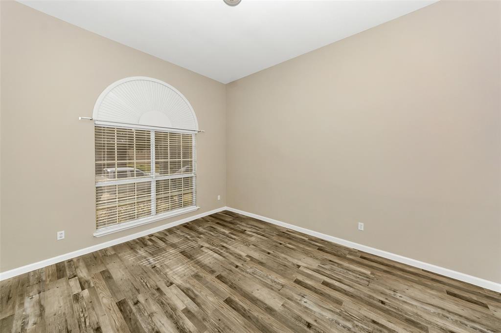 857 Summit Pointe Lewisville, TX 75077 - Photo 27 of 33 an empty room with wooden floor and windows