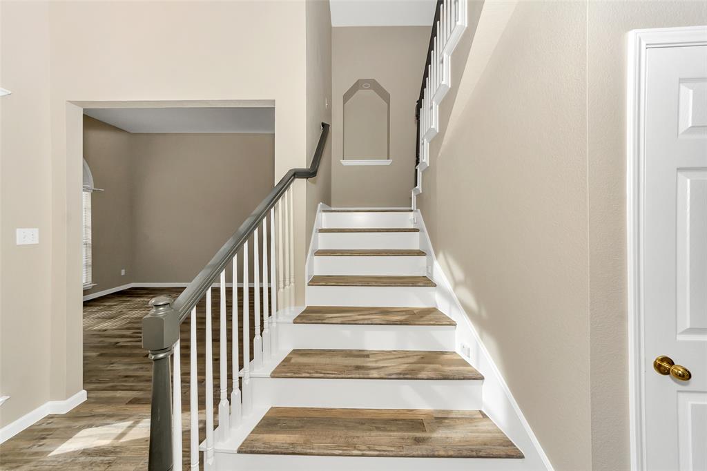 857 Summit Pointe Lewisville, TX 75077 - Photo 6 of 33 a view of staircase with white walls and a window
