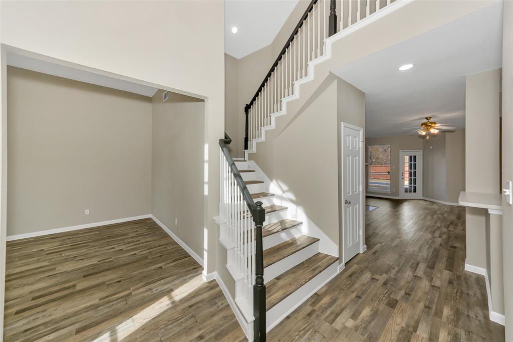857 Summit Pointe Lewisville, TX 75077 - Photo 7 of 33 a view of a hallway view with wooden floor and staircase