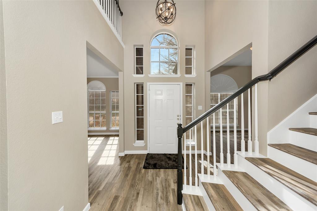 857 Summit Pointe Lewisville, TX 75077 - Photo 8 of 33 a view of a hallway with wooden floor and staircase