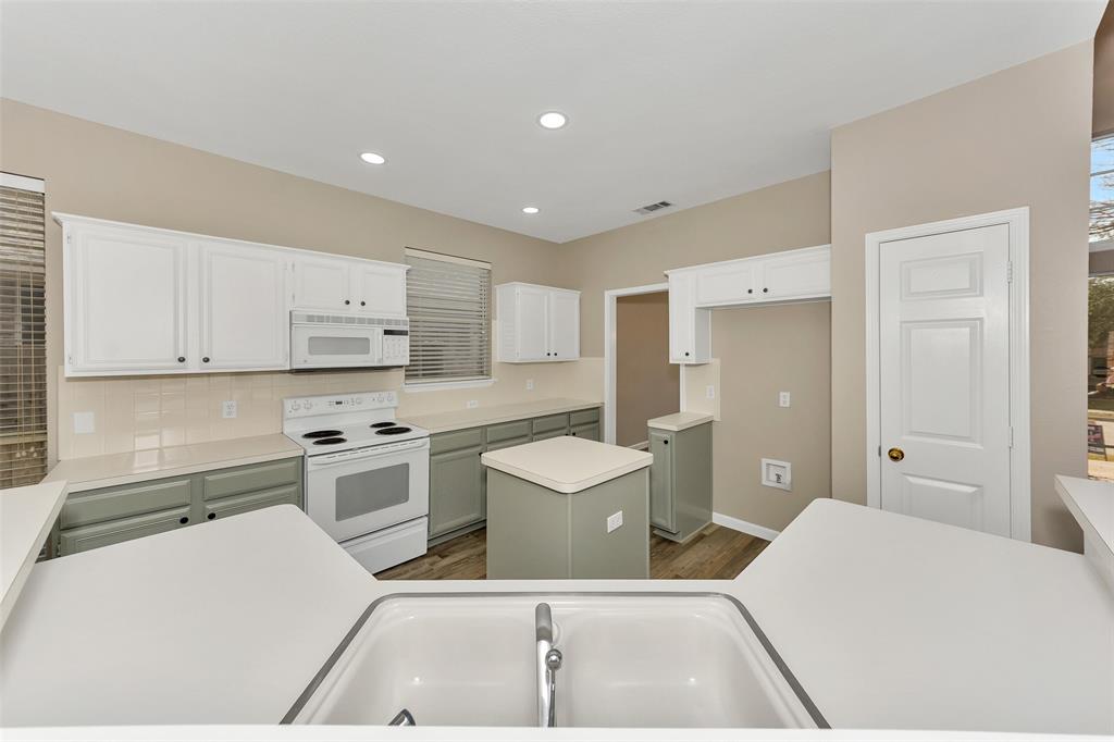 857 Summit Pointe Lewisville, TX 75077 - Photo 10 of 33 a room with a chair and white cabinets