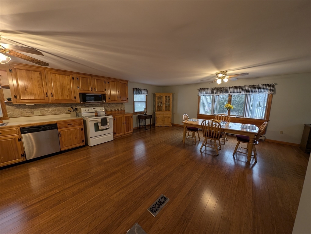 13 Brookfield Road Charlton, MA 01507 - Photo 19 of 41 a kitchen with stainless steel appliances wooden floors and a view of living room