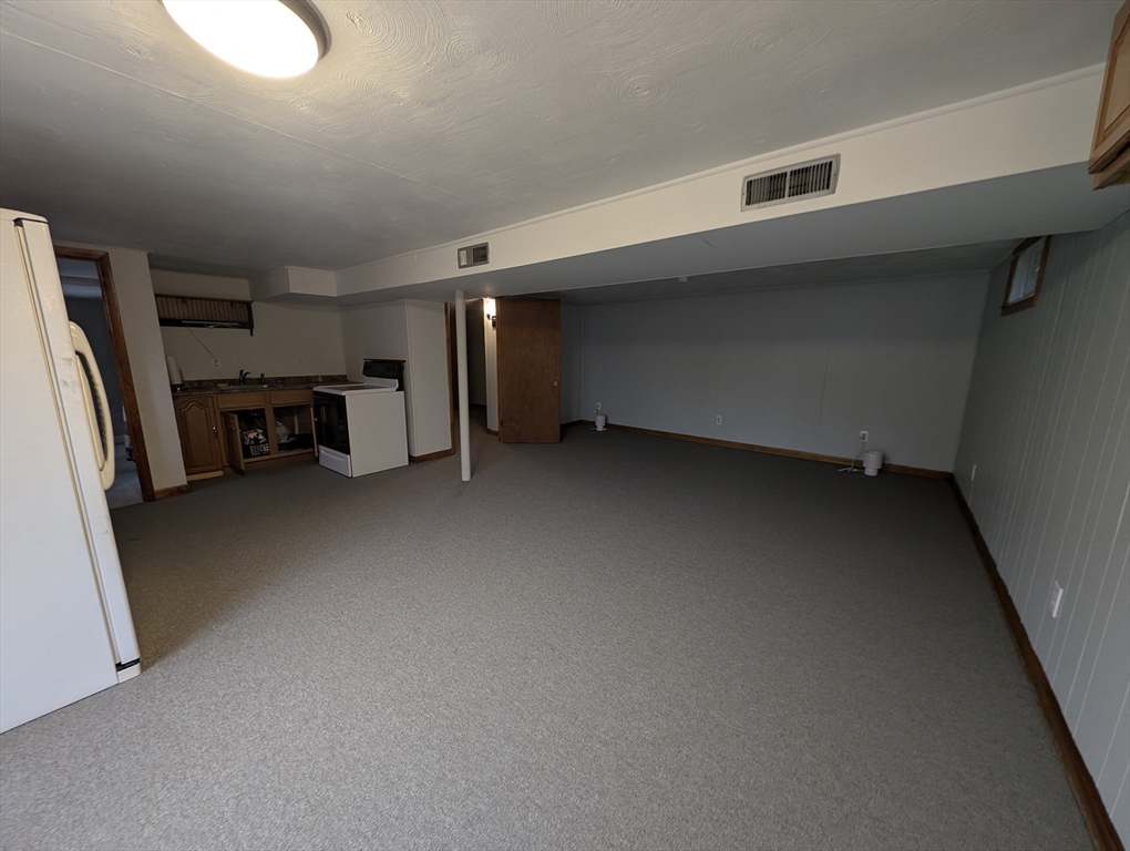 13 Brookfield Road Charlton, MA 01507 - Photo 26 of 41 a view of a livingroom with furniture and a refrigerator
