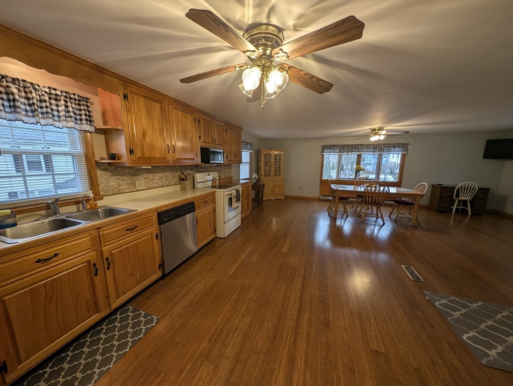 13 Brookfield Road Charlton, MA 01507 - Photo 3 of 41 a kitchen with stainless steel appliances granite countertop a stove a sink dishwasher and a microwave oven with wooden floor