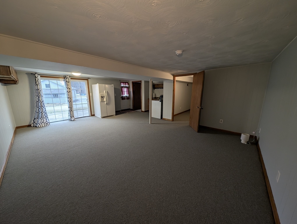 13 Brookfield Road Charlton, MA 01507 - Photo 7 of 41 a view of a livingroom with an empty space and a window