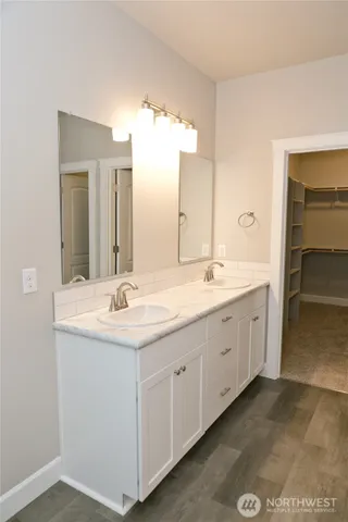 a bathroom with a double vanity sink and a mirror