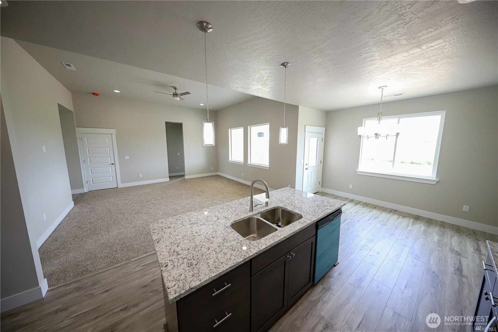 707 A Street Northeast Quincy, WA 98848 - Photo 19 of 27 a kitchen with granite countertop a sink a counter space and wooden floor