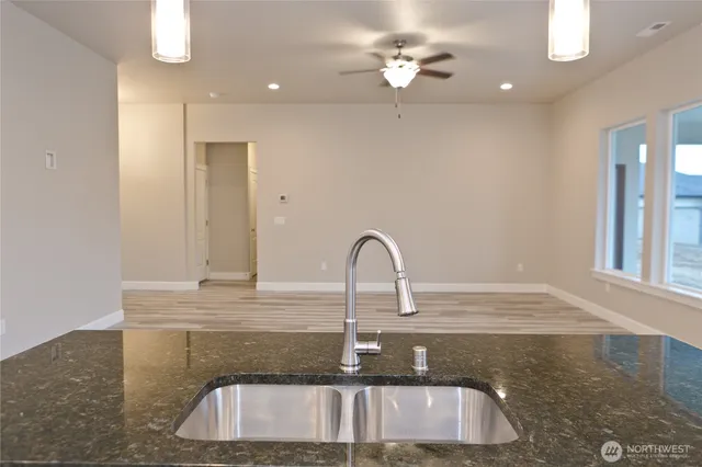a kitchen with kitchen island a sink stainless steel appliances and a counter space
