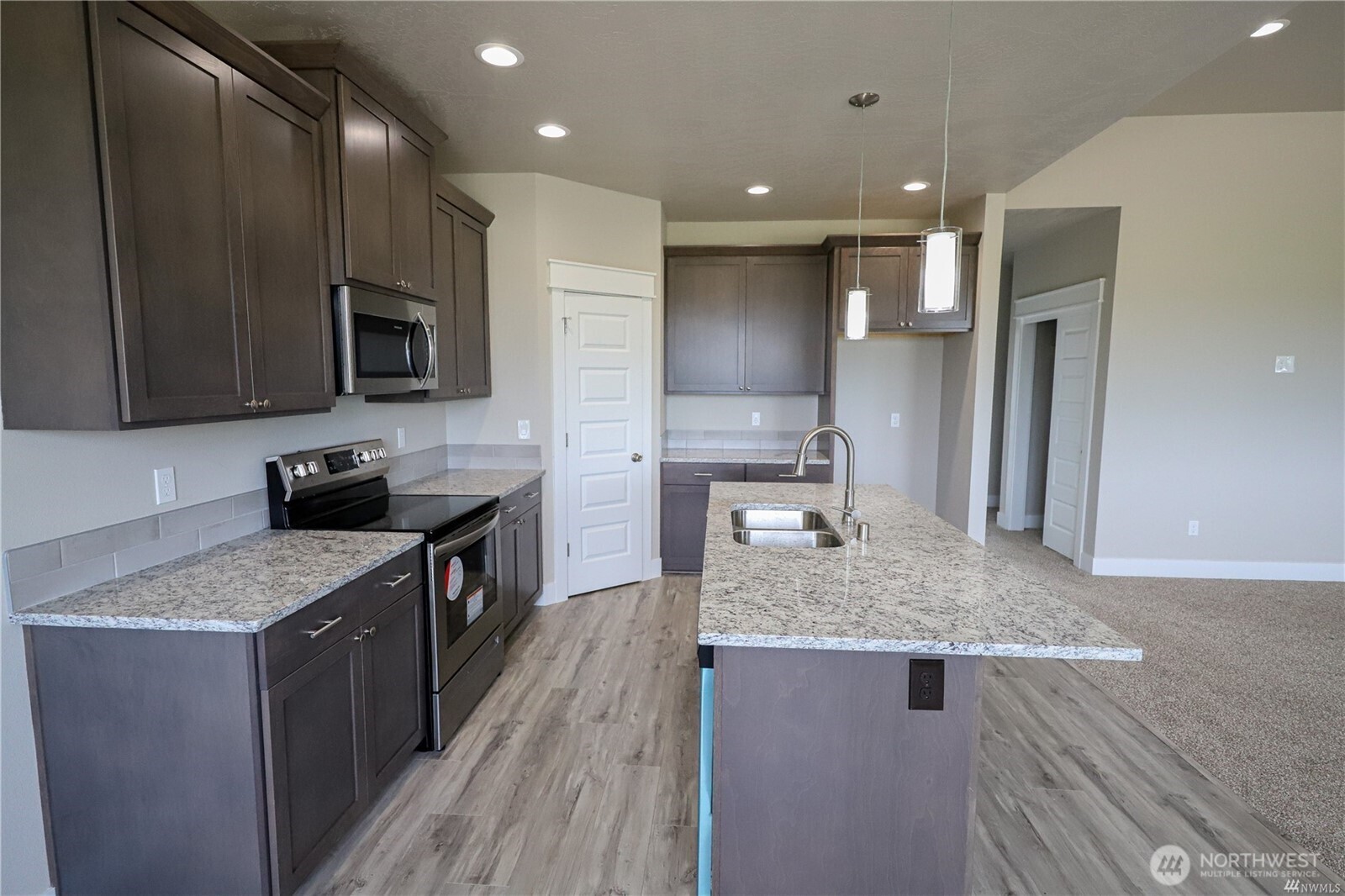 707 A Street Northeast Quincy, WA 98848 - Photo 5 of 27 a kitchen with stainless steel appliances granite countertop a sink stove and refrigerator