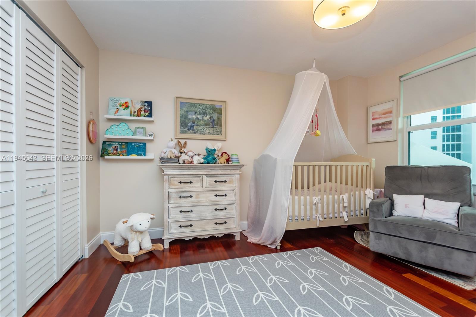 199 Ocean Ln Drive, Unit 807 Key Biscayne, FL 33149 - Photo 15 of 34 a bedroom with furniture and a wooden floor