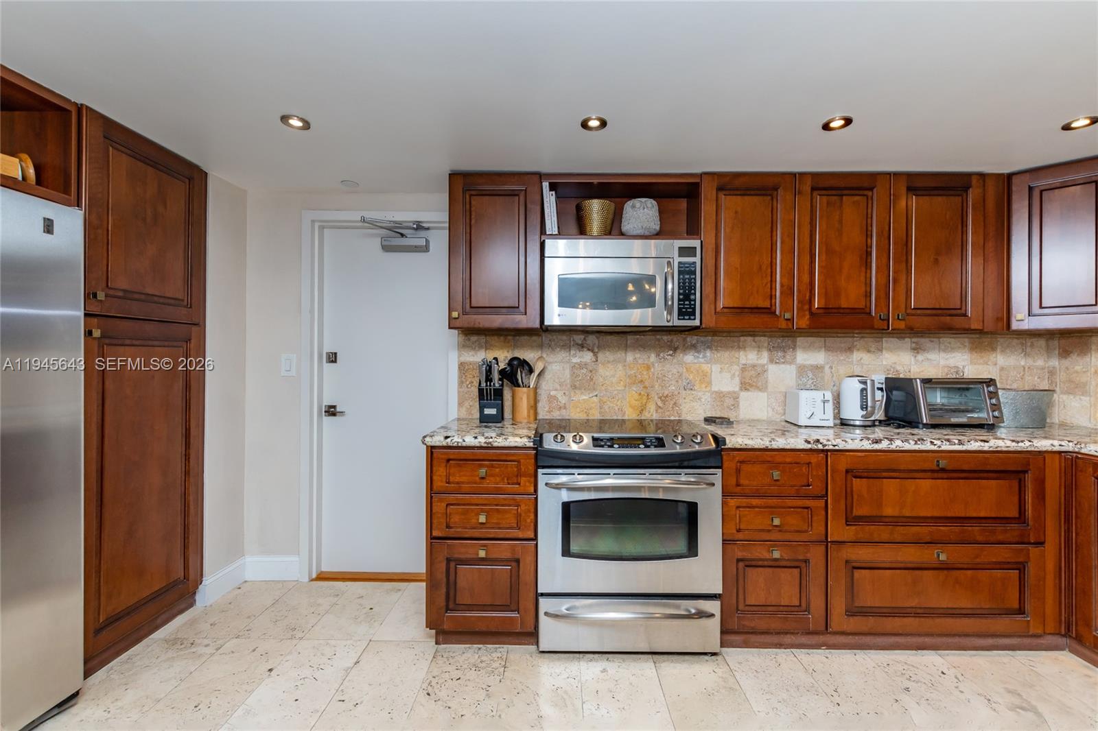 199 Ocean Ln Drive, Unit 807 Key Biscayne, FL 33149 - Photo 24 of 34 a kitchen with stainless steel appliances granite countertop a stove and a refrigerator