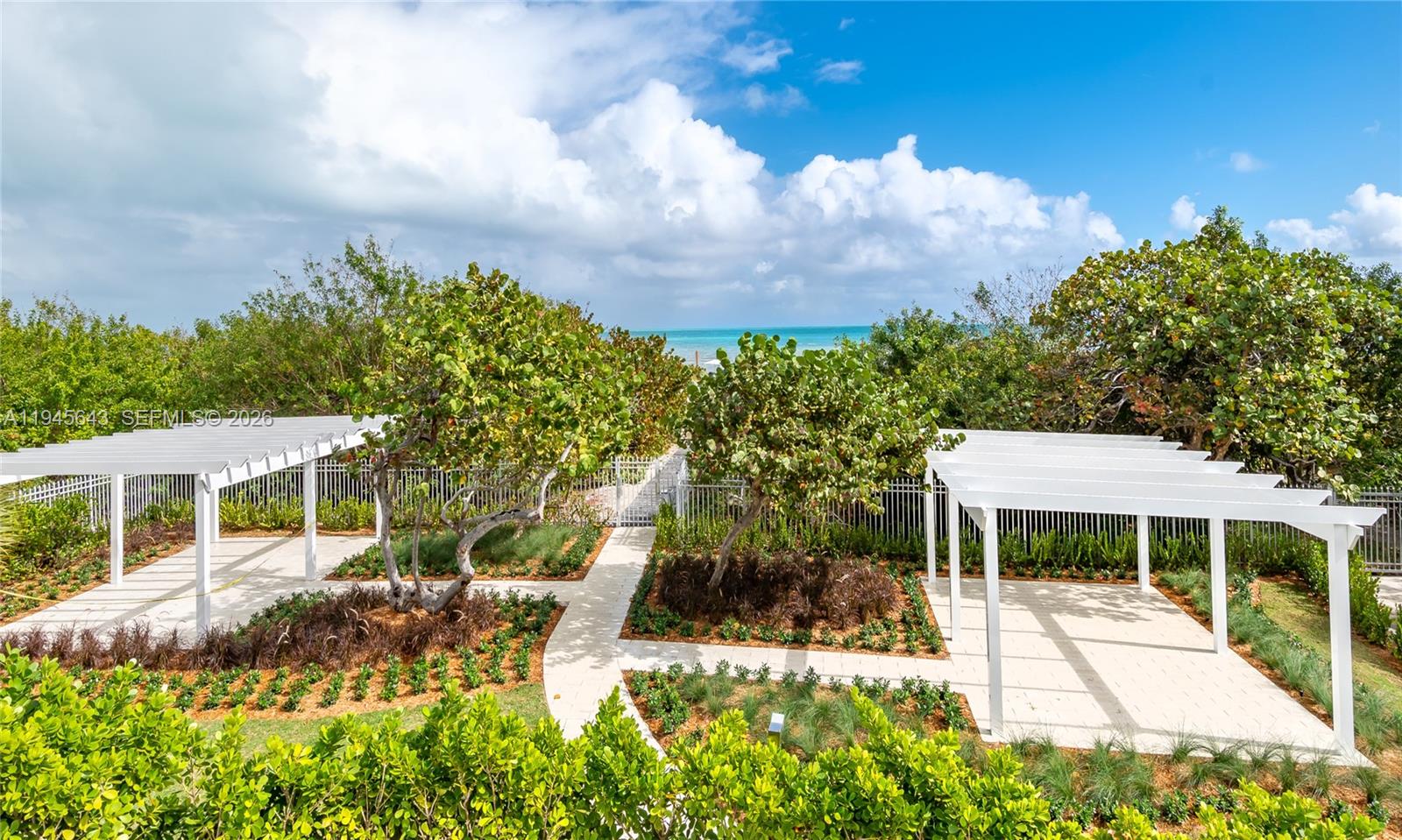 199 Ocean Ln Drive, Unit 807 Key Biscayne, FL 33149 - Photo 32 of 34 a view of a house with a yard and potted plants