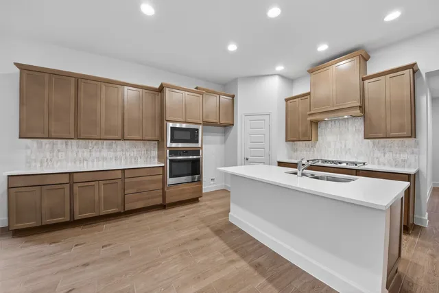 a kitchen with a sink and cabinets