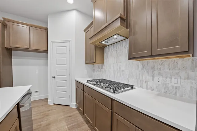 a kitchen with stainless steel appliances granite countertop a stove and a sink