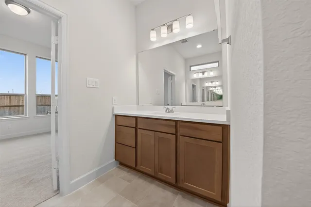 a bathroom with a shower sink and mirror