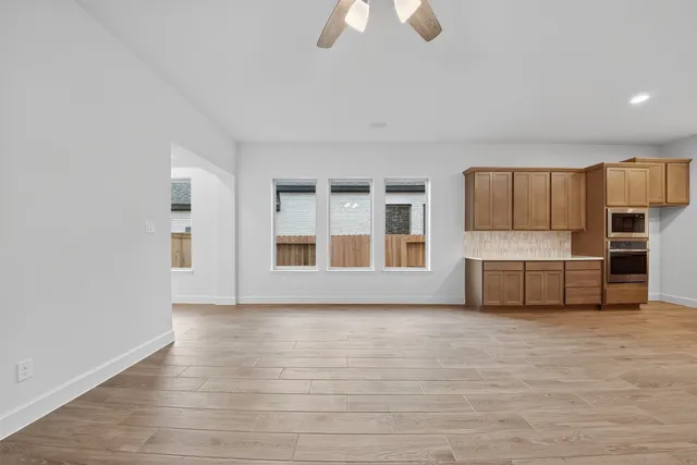 a view of kitchen with stainless steel appliances granite countertop a stove and a refrigerator